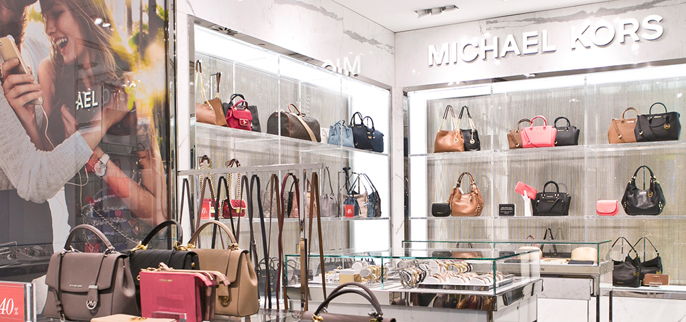 Michael Kors is fed up with department stores damaging its brand